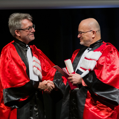 Professor Marc Snir, right, accepts congratulations from ENS de Lyon President Jean-Francois Pinton.