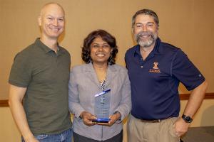 Viveka Kudaligama (center) shortly after receiving the 2018 Graduate College Excellence Award for Graduate Contacts, with Director of Graduate Programs Brian P. Bailey (left) and Director of Online and Professional Programs John C. Hart.