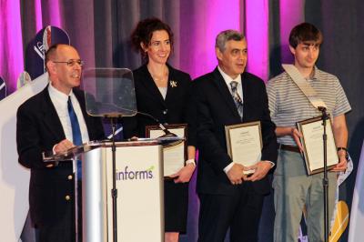 Professor Sheldon Jacobson accepts the IMPACT prize at The Institute for Operations Research and the Management Sciences conference in Phoenix this month. To his left are fellow prize winners Associate Professor Laura Albert, former TSA risk officer Ken Fletcher, and Associate Professor Alexander Nikolaev. 