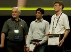 CS PhD student Abhinav Bhatele (center) receives the fellowship at SC'09