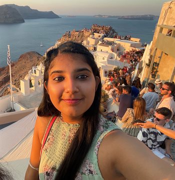 Illinois CS first year undergraduate student Ananya Barman took this selfie in front of a waterside scene.