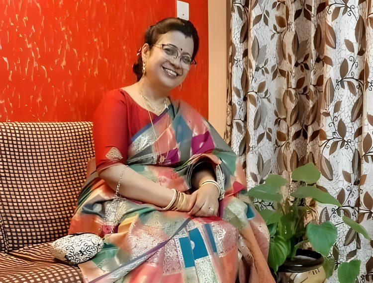 Shubhra Das seated on a couch.