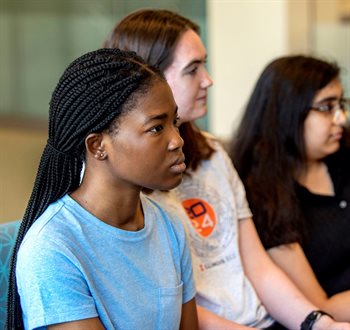 A group of Illinois CS students listen to alumna Parisa Tabriz speak.