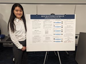 Zhoufan Jia stands in front of her research poster.