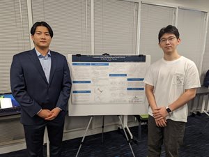 Pai Zheng (left) and Zehao Li stand in front of their research poster.
