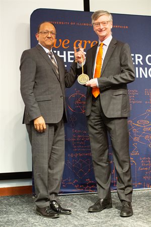 Bill Gropp accepts a medallion signifying the Grainger Distinguished Chair in Engineering from Grainger Dean Rashid Bashir.