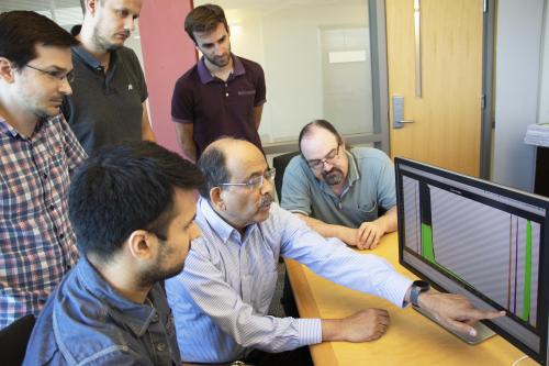 Professor Laxmikant &quot;Sanjay&quot; Kale works with members of his research group earlier this year.
